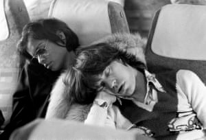 Mick and Bianca Jagger asleep on the plane home after celebrating the last night of the Rolling Stones 1973 European tour in Berlin