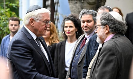 The German president Frank-Walter Steinmeier (left) is welcomed by members of the Jewish community at a synagogue in Berlin on Friday.