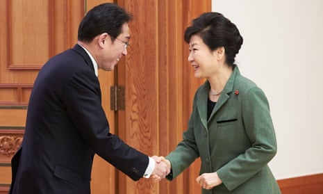 South Korea’s president Park Geun-hye (right) shakes hands with Japan’s foreign minister Fumio Kishida on 28 December.