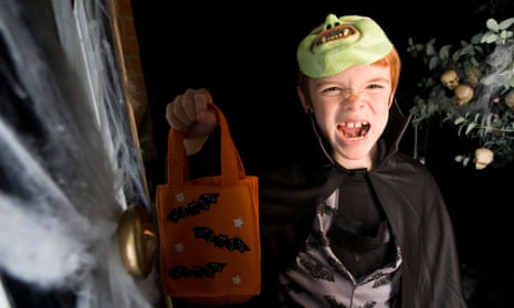 A young trick or treater celebrates Halloween.