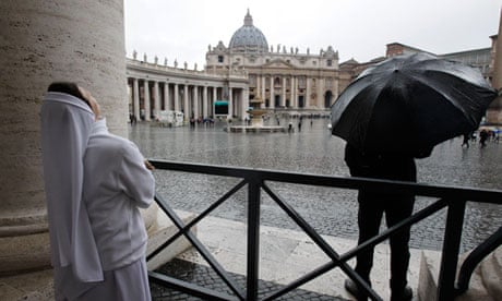 A nun looks up in St Peter's Square on the second day of the papal conclave on 13 March 2013.