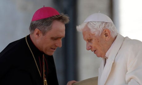 Pope Benedict XVI talks to his personal secretary George Gaenswein after his final general audience