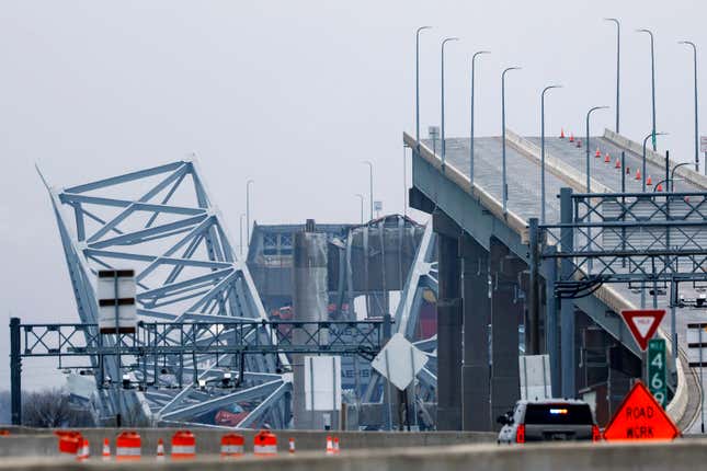 The collapsed Francis Scott Key Bridge is seen in the background of the on-ramp to the bridge on March 27, 2024 in Baltimore, Maryland. Two survivors were pulled from the Patapsco River and six missing people are presumed dead after the Coast Guard called off rescue efforts. A work crew was fixing potholes on the bridge, which is used by roughly 30,000 people each day, when the ship struck at around 1:30am on Tuesday morning. The accident has temporarily closed the Port of Baltimore, one of the largest and busiest on the East Coast of the U.S. 