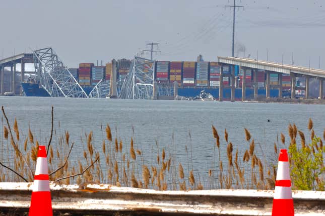 The cargo ship Dali is shown after running into and collapsing the Francis Scott Key Bridge on March 26, 2024 in Baltimore, Maryland. According to reports, rescuers are still searching for multiple people, while two survivors have been pulled from the Patapsco River. A work crew was fixing potholes on the bridge, which is used by roughly 30,000 people each day, when the ship struck at around 1:30am on Tuesday morning. The accident has temporarily closed the Port of Baltimore, one of the largest and busiest on the East Coast of the U.S. 