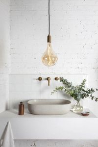 A clean chic all white bathroom.. definitely goals. The wide bathtub like sink, white painted bricks, with gold accents. #bathroomsink
