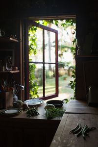 Tara Hurst: Surrounded by beautiful gardens 'The Tree House' as it's been suitably named is the quintessential Pacific Northwest dwelling. Built around the great-grandfather of cedars... the kitchen window, framed by lush ivy. Photograph by Kelly Brown