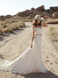 two piece lace wedding gown || bohemian wedding dresses || romantic bride || crochet-lace wedding dress || flutter off the shoulder sleeves || fitted bodice that hugs the hips and flares just below the knee || full sweeping train || daughters of simone