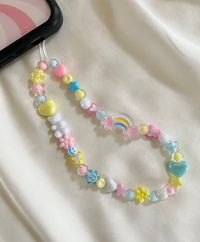 ♡ Pastel Rainbow Phone Charm/Strap ♡ Approximately 7.5 inches in length from top of cord to bottom of beads ♡Materials:  * white waxed cord  * acrylic beads    ♡ PHONE CHARM CARE:  * Please note all of our phone charms are meant to be used as an accessory and not meant to hold your phone * Excessive pulling on phone charm may cause breakage * We are not responsible for any charms that break once they are in your care ♡ Beads and bead colors may vary but will look very similar to the phone charm