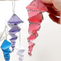 This Folded Paper Icicle Craft looks fantastic in white or colours. These homemade icicles are easy to make with the free printable pattern, just print, cut and fold! A lovely Winter craft for kids. #icicles #iciclecrafts #winter #wintercrafts #kidscrafts #papercrafts #origami #kidscraftroom #paperfolding #christmascrafts #christmasdecor #icicle #wintercraftsforkids