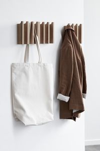 This modern and minimal natural oak coat rack is sculptural minimalism that serves a purpose. Inspired by the aesthetics of conic pillars, this design features 4 convenient hooks. When not in use, it looks like multi-dimensional minimal wall decor. We love how this modern and minimal coat rack adds a hint of elegance to a minimal entryway, or even a closet. This coat rack looks great when paired together, but only one is needed in a smaller space.