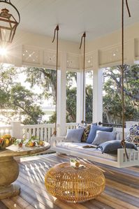 Who wouldn't love to spend the day relaxing on this beautiful, Victorian porch? This extra-tall ceiling draws attention to the home’s vintage style and provides plenty of room to attach a coordinating swing. | Southern Living Idea House via Hank Miller Team   #porches #homedesign #designinspo #frontporches #homeexteriors #exteriordesign #porchswings