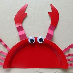 a paper plate crab with googly eyes on it