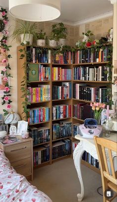 a room filled with lots of books and plants