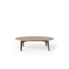an oval wooden table with black legs
