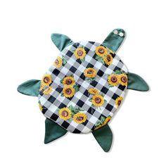a green turtle with sunflowers on it's back