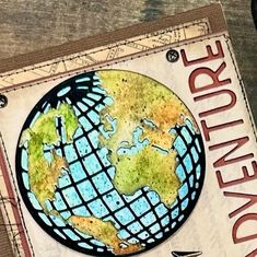 a card with the words adventure written on it and a drawing of a world globe