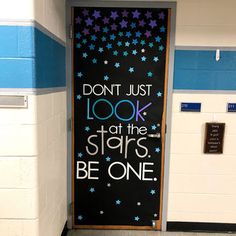 a door with the words don't just look at the stars be one painted on it