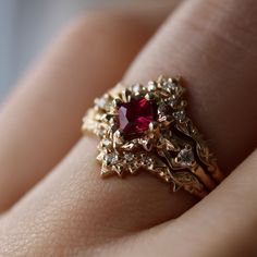 This epic ring is inspired by the Goron's Ruby in the Legend of Zelda: Ocarina of Time. On either side are super tiny dodongos holding the settings for accent diamonds. CUSTOMIZE GEMSTONES ✶ solid 14 karat recycled yellow, white, or rose gold✶ band measures 1.6mm wide x 1.4mm thick✶ natural center stone: 0.29 ct. A grade princess cut ruby✶ lab-grown center stone: 0.29 ct. princess cut lab-grown ruby✶ accent stones: 0.04 tcw. VS clarity round brilliant cut conflict-free diamondsThis ring will be Engagements, Jewellery Rings, Ring Designs, Gold Jewelry, Jewelry Rings, Ring, Fine Jewelry, Jewelry Ideas, Jewelry Design