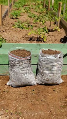 two bags filled with dirt sitting on the ground