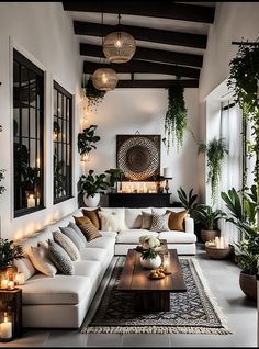 a living room filled with white couches and lots of potted greenery on the walls