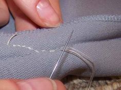 someone is stitching something on the side of a piece of fabric with a needle