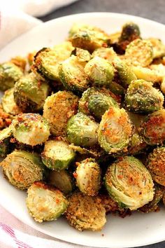a white plate topped with brussel sprouts covered in seasoning