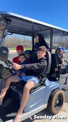 three children are riding in a golf cart