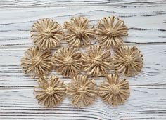 several pieces of jute are arranged on a white wooden surface with knots in the shape of flowers