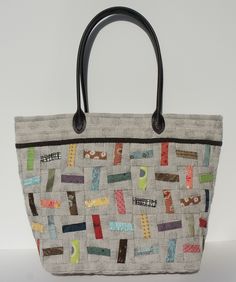 a handbag made with fabric and leather handles