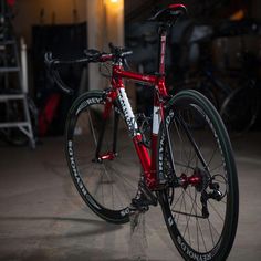 a red and black bike parked in a garage