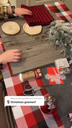 two children are making homemade christmas cookies on the kitchen table with red and white checkered cloth