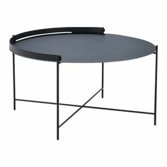 a round table with black metal legs and an oval tray on the top that has a curved edge
