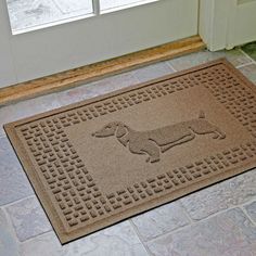 a door mat with a dachshund dog on it in front of a door