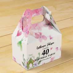 a pink and white birthday party box on top of a wooden table with the number 40 printed on it