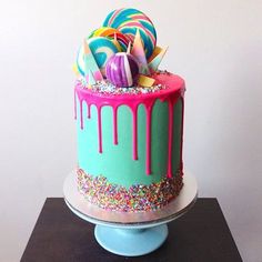 a colorful cake with sprinkles and candies on top