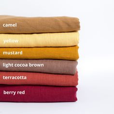 four different colors of linens stacked on top of each other with the words camell mustard mustard light cocoa terracotta berry red
