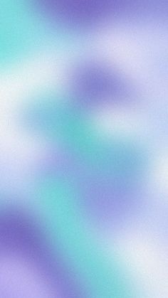 an abstract blurry background with blue and purple hues in shades of lavender, teal, and green