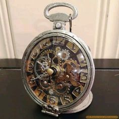 an antique pocket watch is sitting on a table