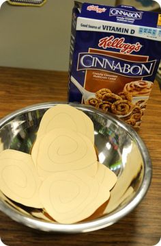 a metal bowl filled with cut out cookies