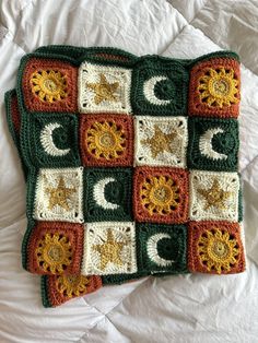 a crocheted blanket with sun and moon on it