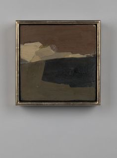a painting hanging on the wall next to a white wall with a brown and black frame