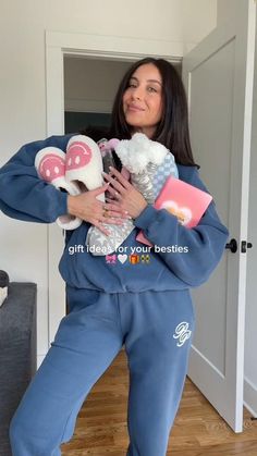 a woman is holding two stuffed animals in her arms and posing for the camera while wearing pajamas