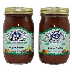 two jars of apple butter sitting next to each other