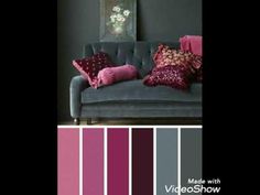 a living room with grey couches and pink pillows on top of the couch is featured in this color scheme