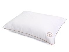 a white pillow sitting on top of a bed