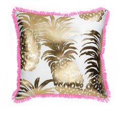a pink and gold pillow with pineapples on it