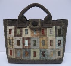a handbag made out of patchwork material with handles and straps on the handle