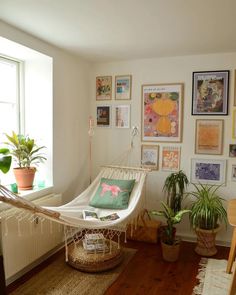 a hammock in a room with pictures on the wall