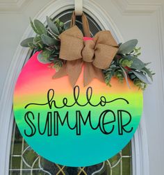a door hanger with the words hello summer painted on it, and a bow