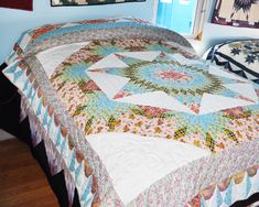 a bed with a quilt on top of it